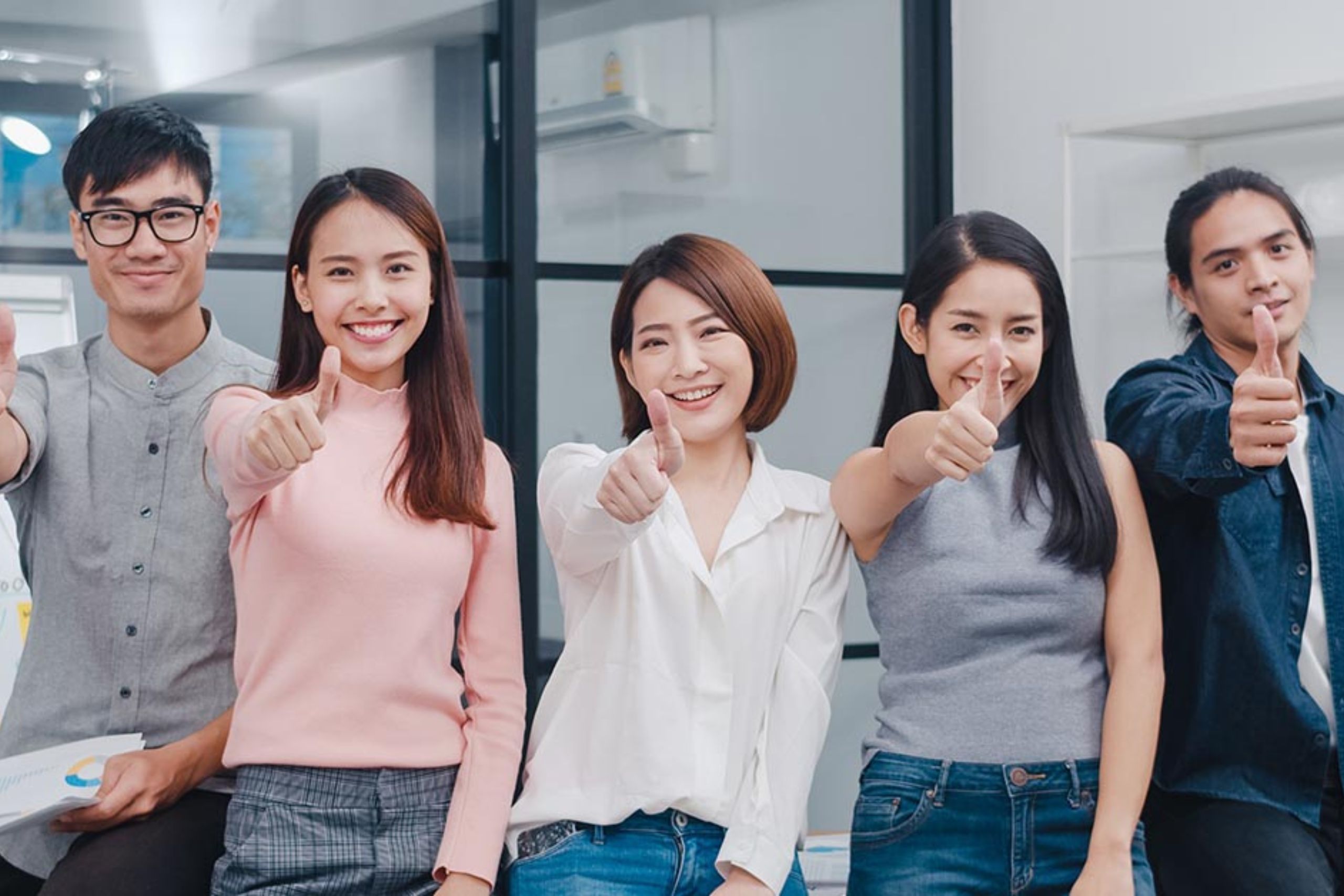 DBD HUB corporate wellness team in Singapore posing for a group photo with thumbs up, representing employee satisfaction, positive workplace culture, and strong team spirit.