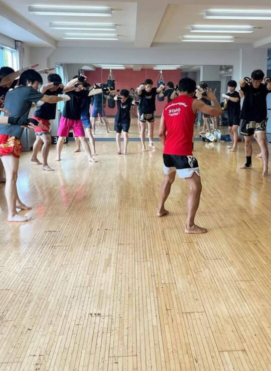 Corporate employees engaged in a dynamic group fitness class by DBD Health Hub, promoting physical wellness, teamwork, and workplace energy through expert-led sessions