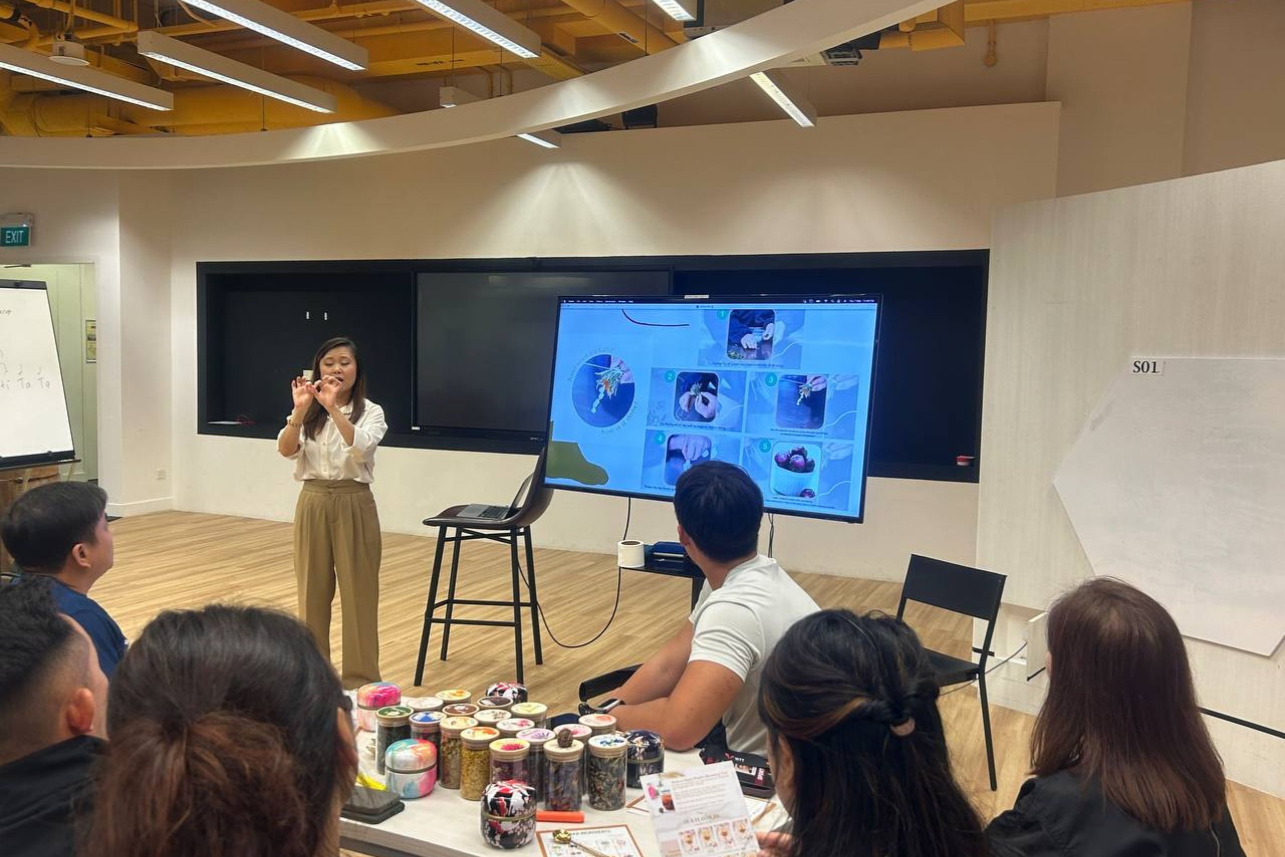 Employees enjoying a hands-on lifestyle workshop by DBD Health Hub, featuring creative wellness activities like tea blending, art jamming, and mindful movement for workplace well-being