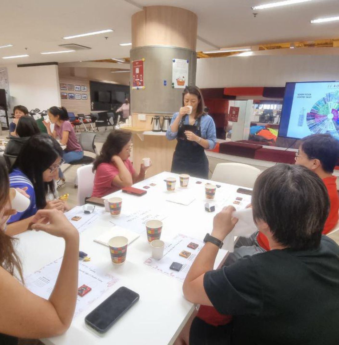DBD HUB Lifestyle Workshop—employees enjoying a Specialty Coffee & Chocolate Pairing session featuring Indonesian brands JJ Royal Coffee and Krakakoa; tasting unique flavor combinations in a guided sensory experience to promote workplace wellness, team bonding, and employee engagement.