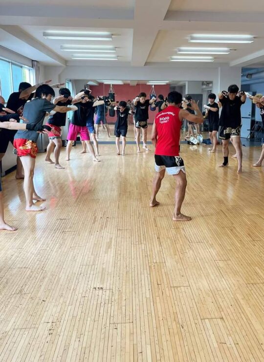 Corporate employees engaged in a dynamic group fitness class by DBD Health Hub, promoting physical wellness, teamwork, and workplace energy through expert-led sessions