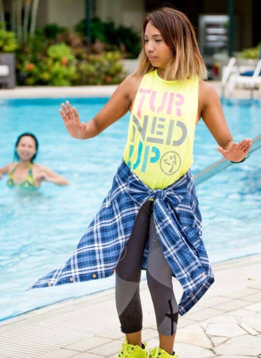 Corporate employees engaged in a dynamic group fitness class by DBD Health Hub, promoting physical wellness, teamwork, and workplace energy through expert-led sessions