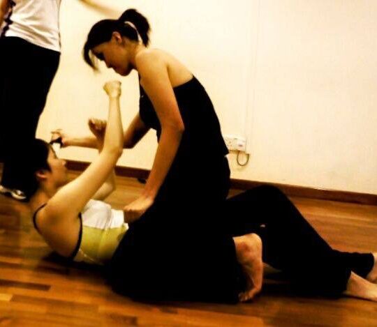 Corporate employees engaged in a dynamic group fitness class by DBD Health Hub, promoting physical wellness, teamwork, and workplace energy through expert-led sessions