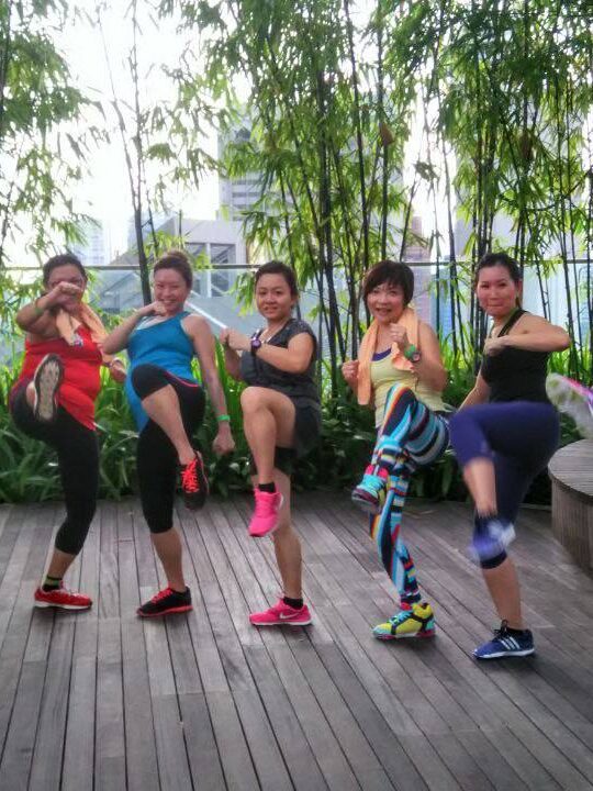 Corporate employees engaged in a dynamic group fitness class by DBD Health Hub, promoting physical wellness, teamwork, and workplace energy through expert-led sessions -